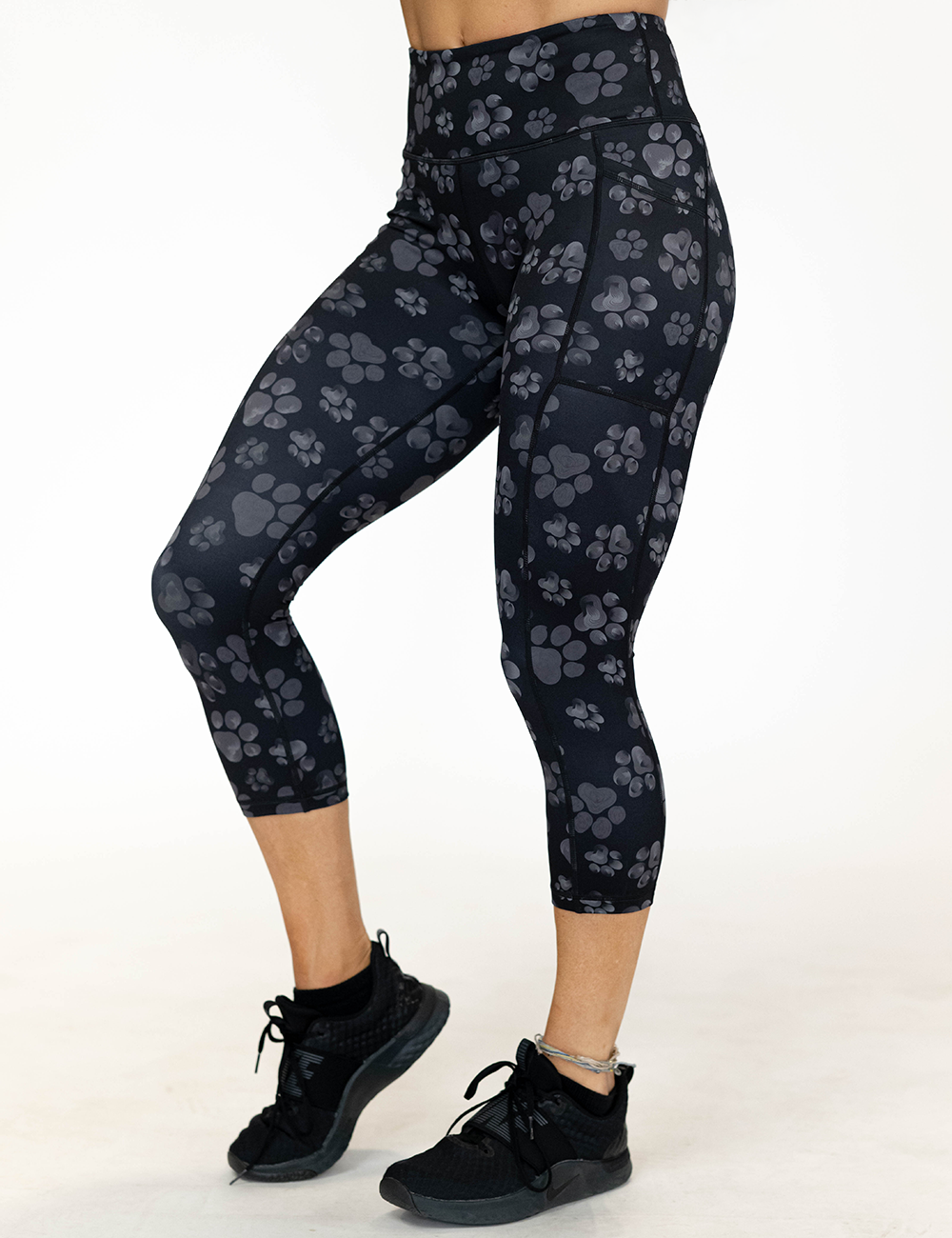 model wearing the grey pawprint against a black background capri leggings facing the front