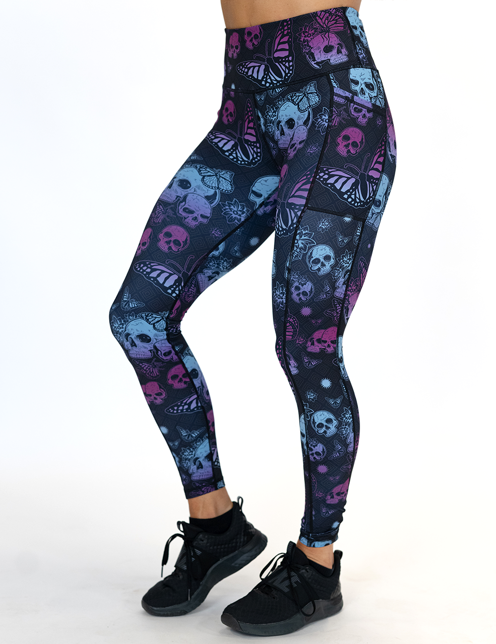 model wearing the blue and purple skulls surrounded by butterflies full length leggings