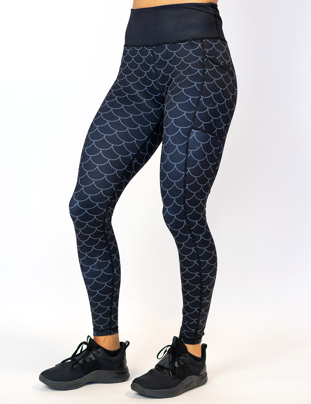 dragon scale outline against a dark background pattern full length leggings facing the front against a white background