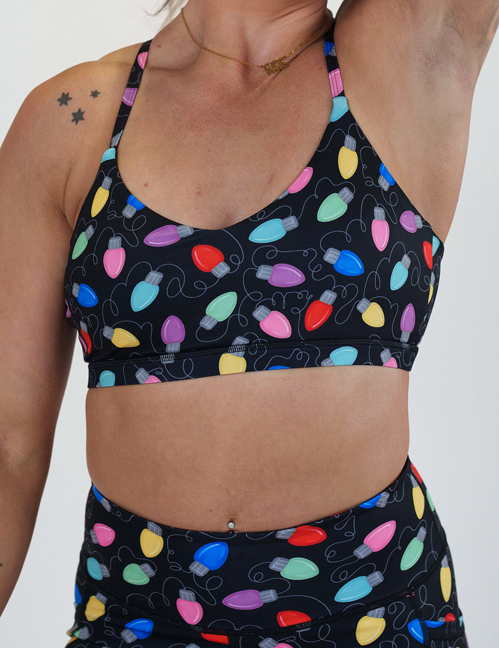 front of the Christmas lights patterned sports bra