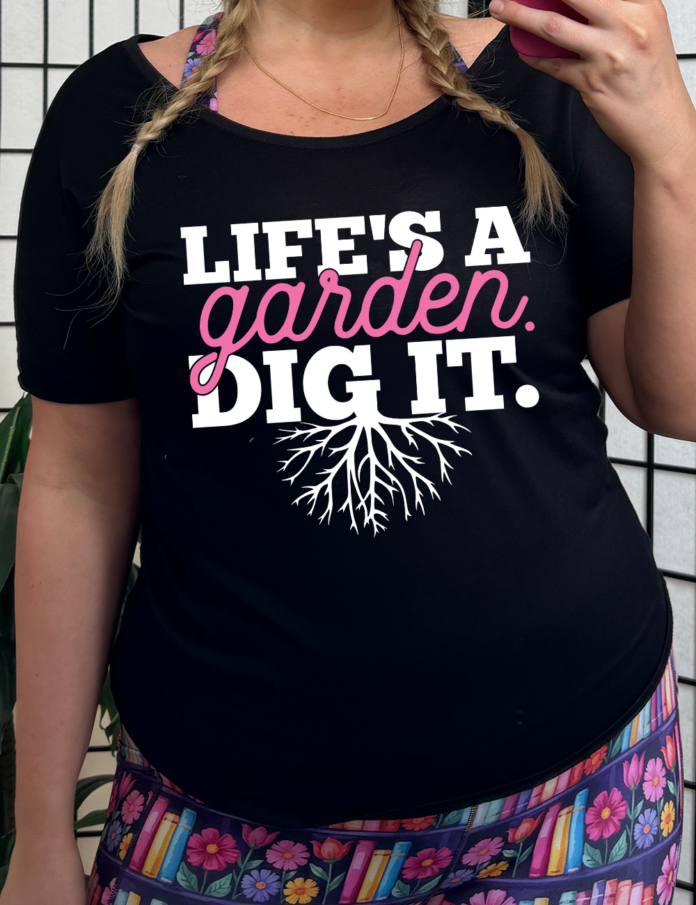 black slouchy tee with the words "Life's a garden. Dig it." on it, with the "g" having roots growing down out the bottom of it