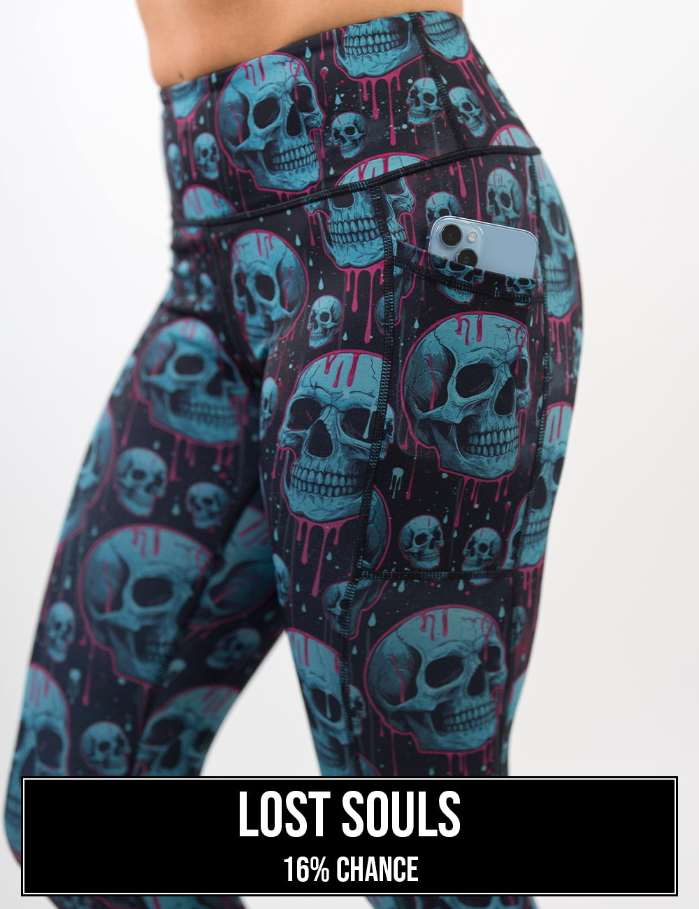 side view of the blue skulls with pink drips leggings with a phone in its pocket, the name of this print is lost souls and it has a 16% chance of being unboxed