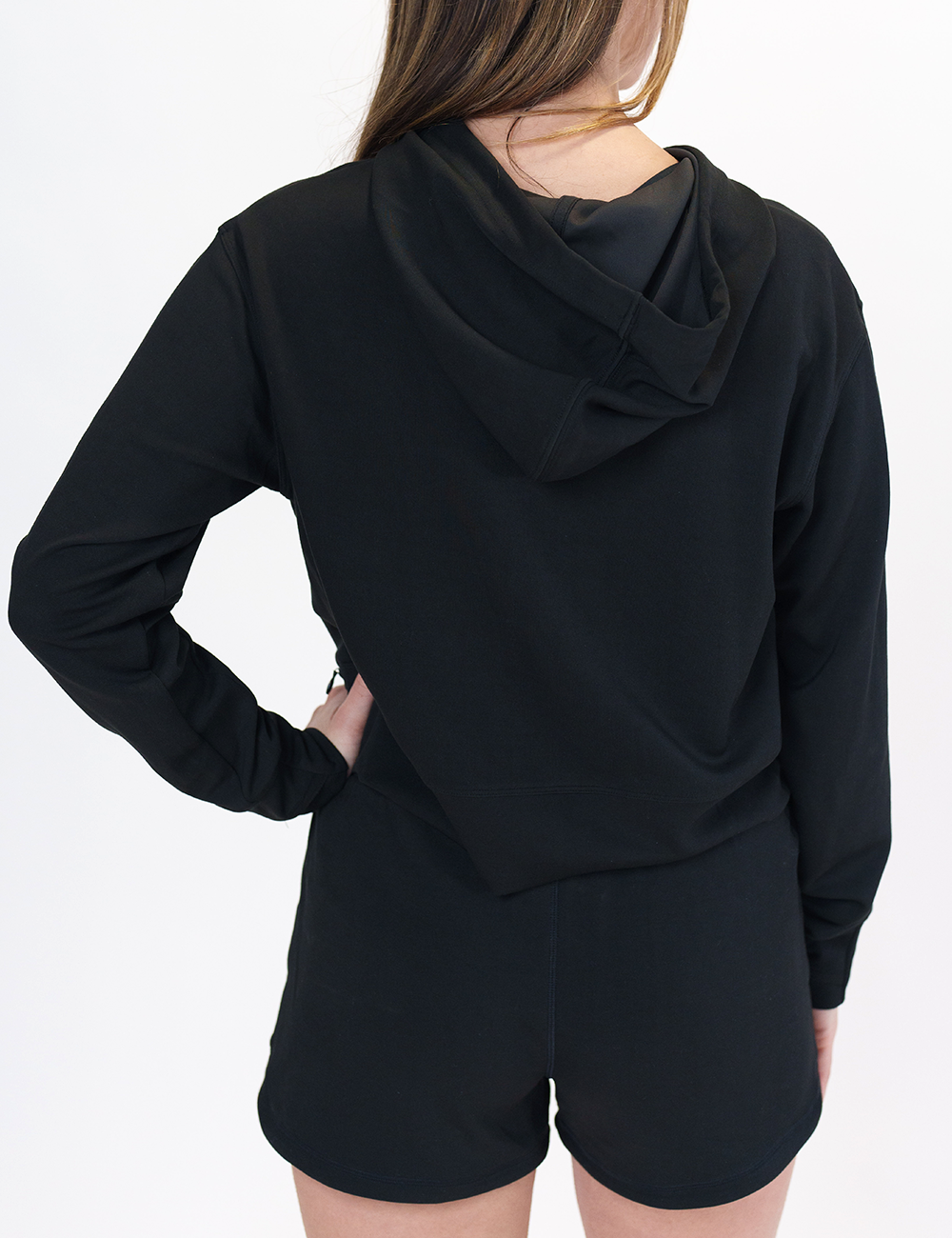 back of the black drawstring hoodie against a white background