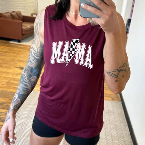 model wearing a maroon muscle tank with the saying "mama" on it and a checkered lightning bolt.