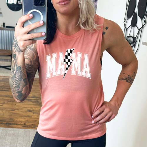 model wearing a peach uscle tank with the saying "mama" on it and a checkered lightning bolt.