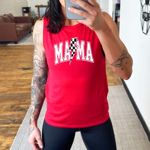 model wearing a red muscle tank with the saying "mama" on it and a checkered lightning bolt.