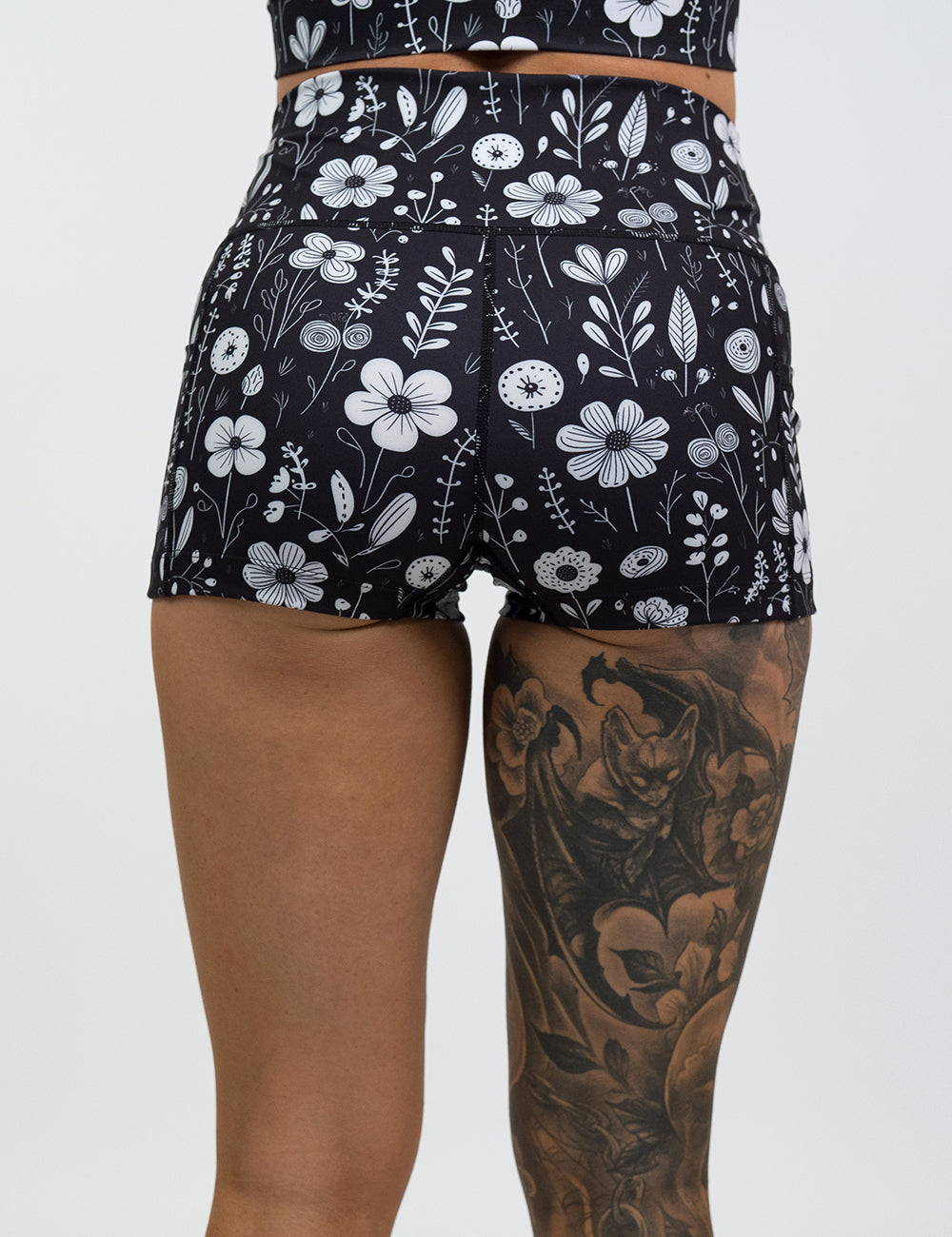 back of the 2.5 inch black and white floral shorts against a white background