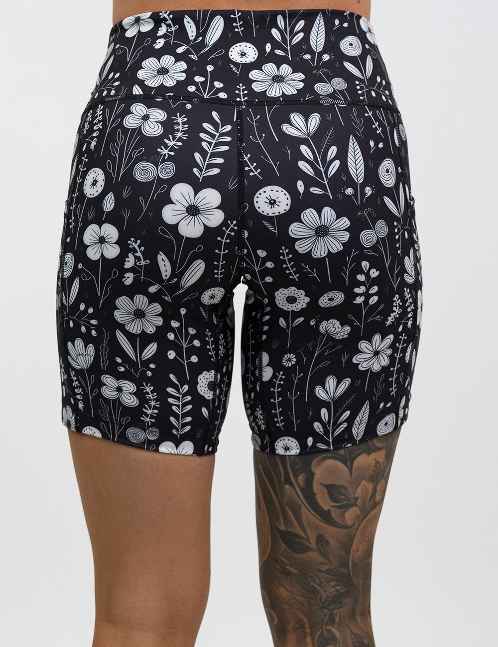 back of the 7 inch black and white floral shorts against a white background