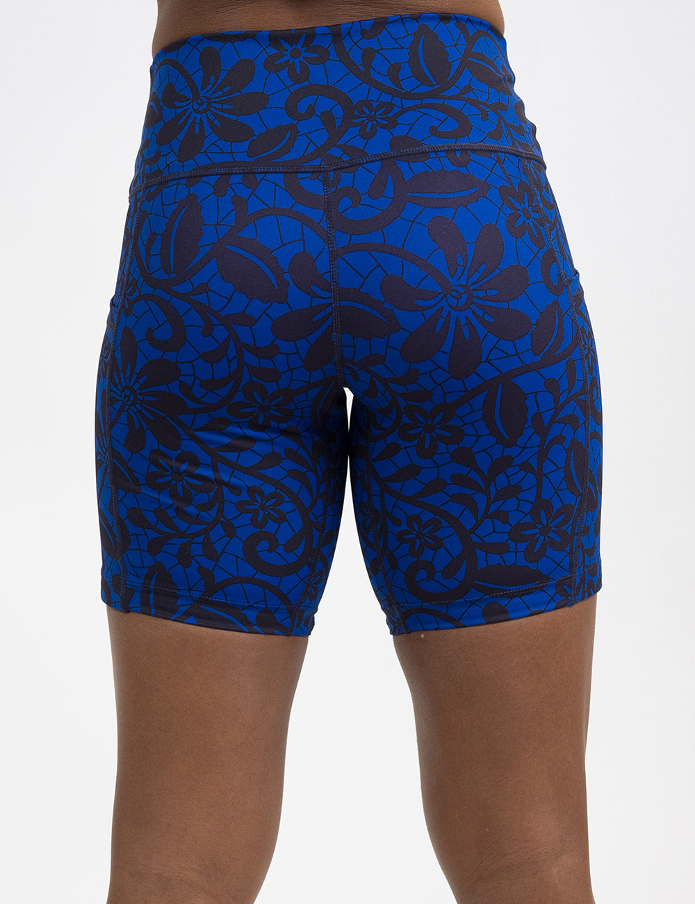 back of the 7 inch black floral against a dark blue background shorts against a white background