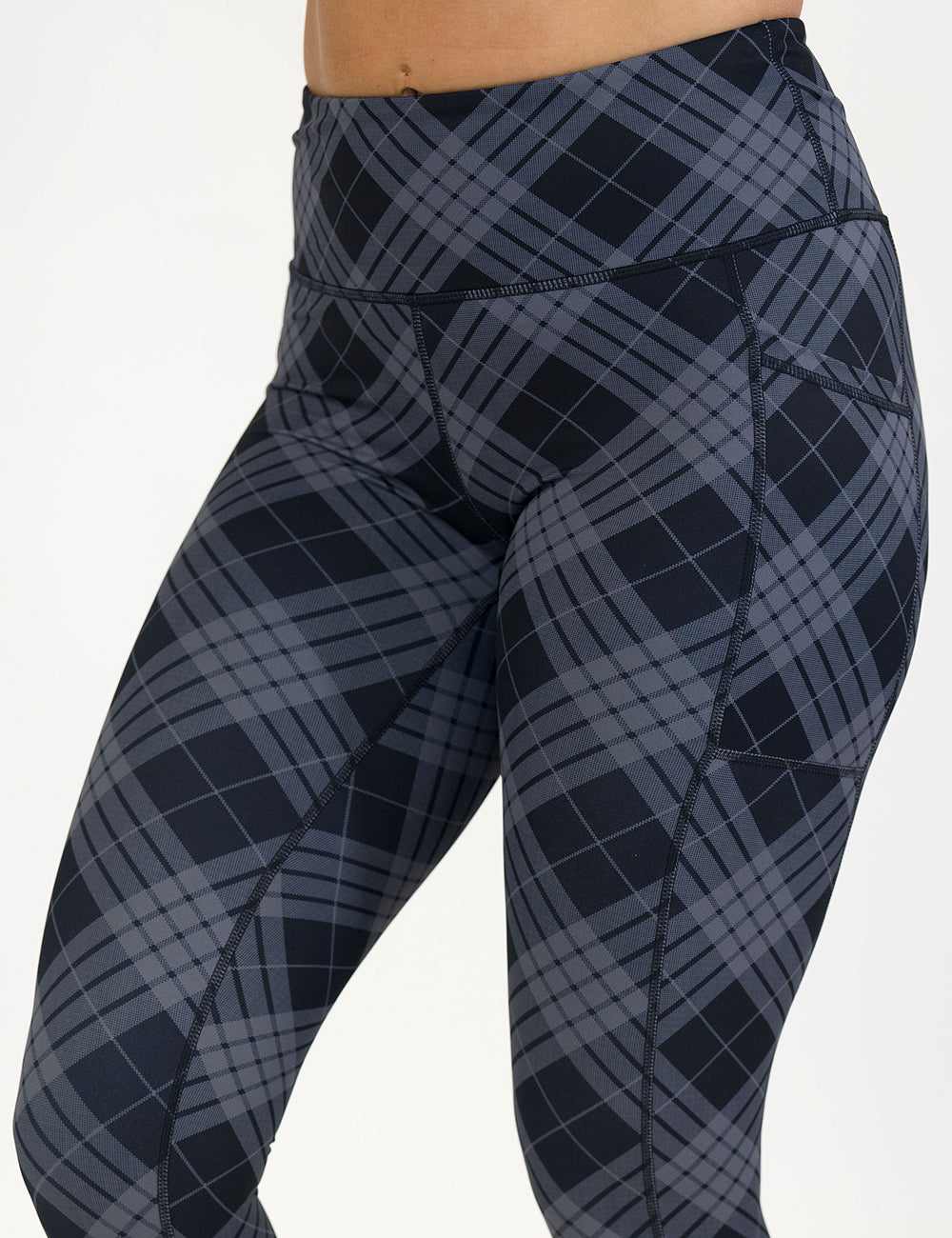 Plaid patterned leggings on a white background