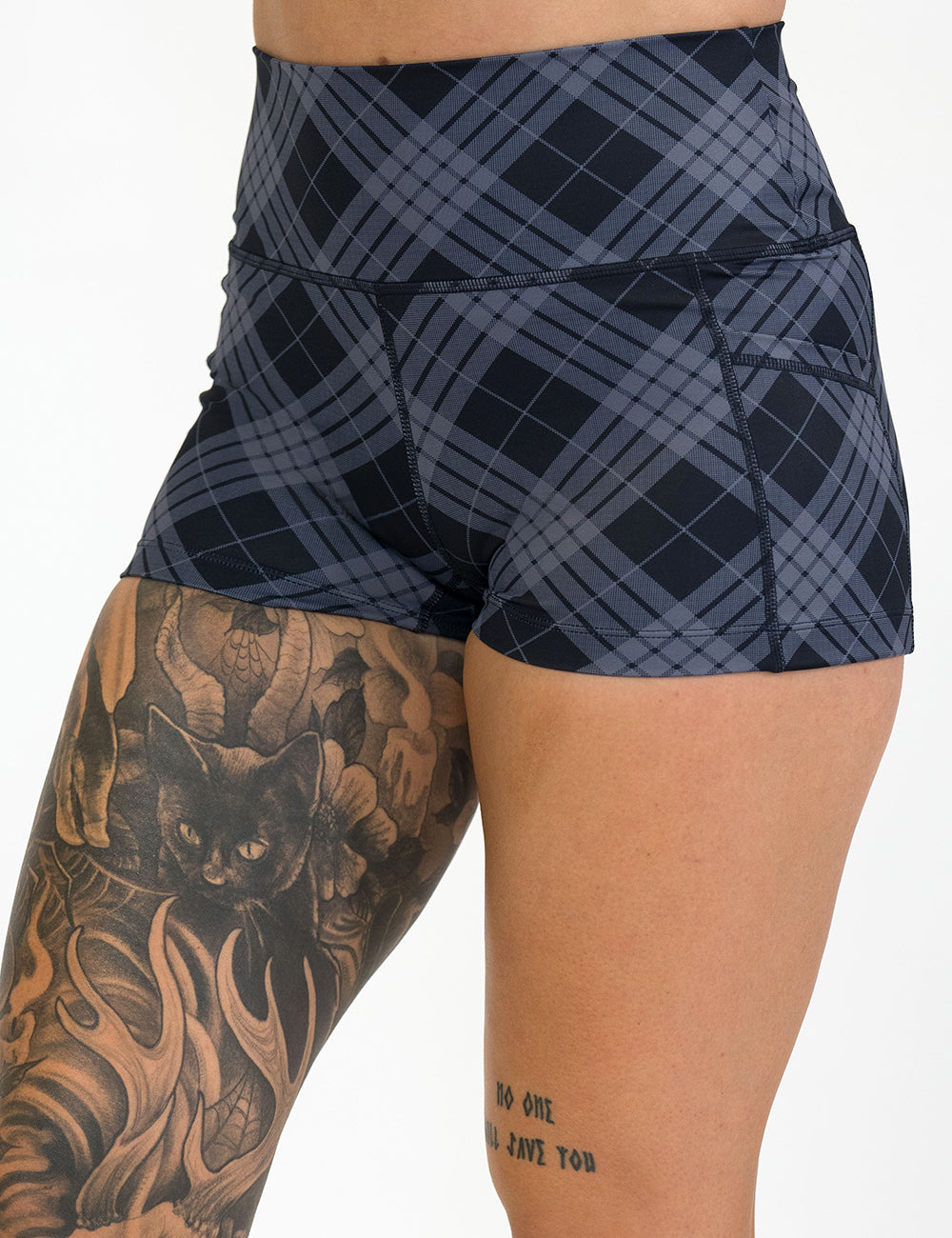 front of the 2.5 inch monochrome colored plaid shorts against a white background