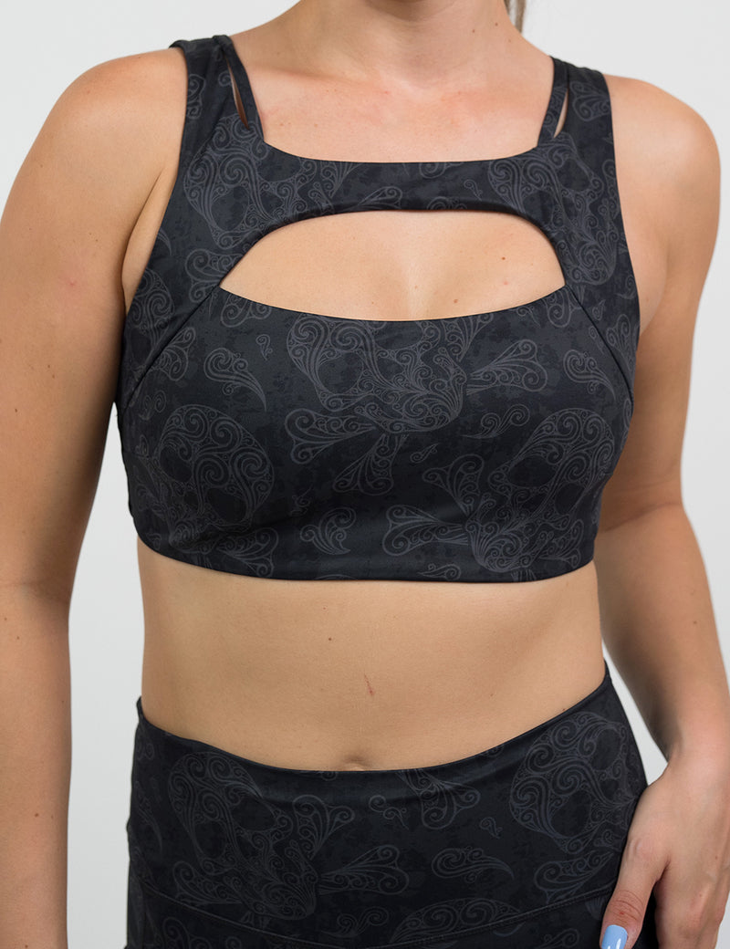 front of dark pirate themed skull and cross bones print vista bra against a white background