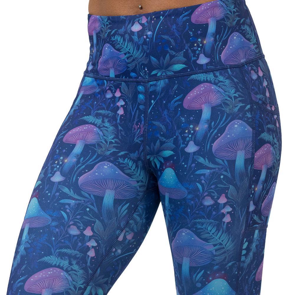 leggings with a blue and purple mushroom and foliage design on a white background