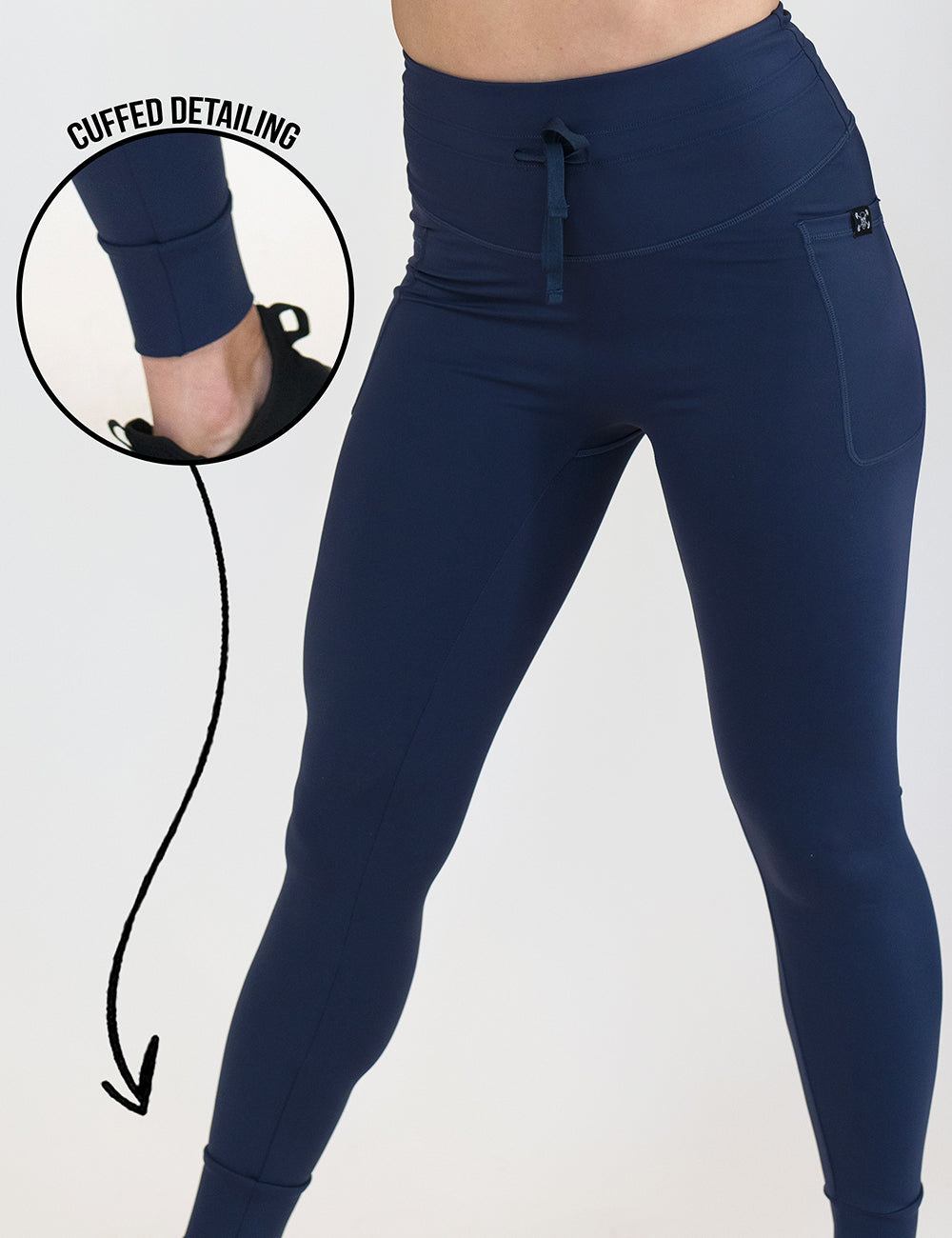 close up of the dark blue draw string leggings with a close up of the cuffed detail against a white background