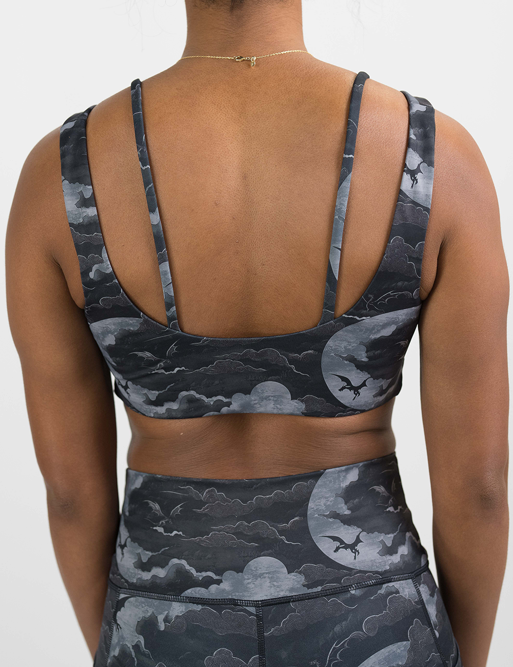 back of the dark dragon against moonlit clouds pattern vista bra against a white background