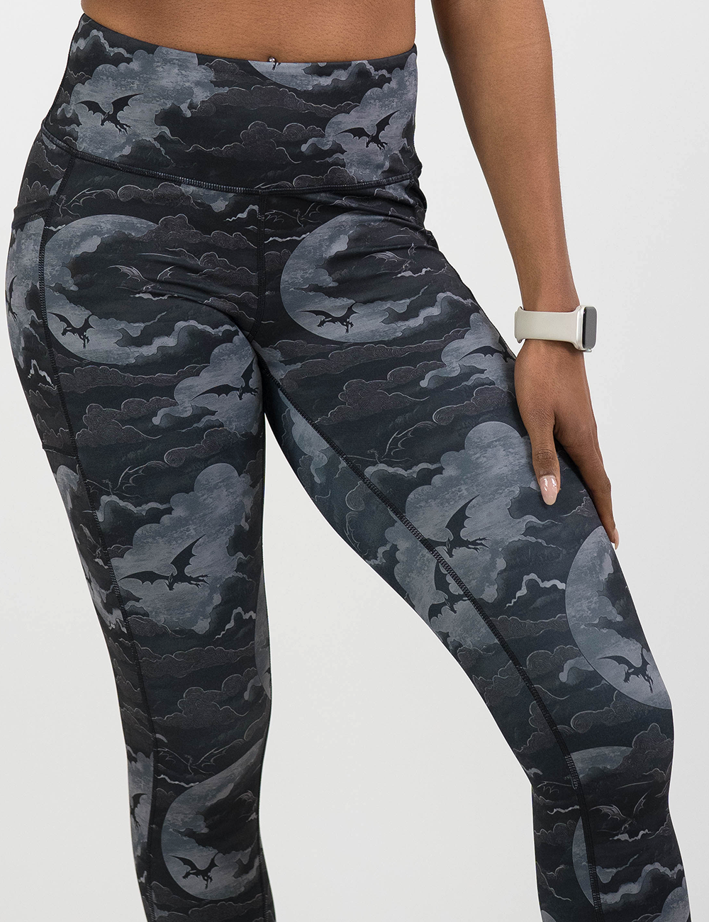 close up of the dark dragons against a moonlight night sky leggings against a white background
