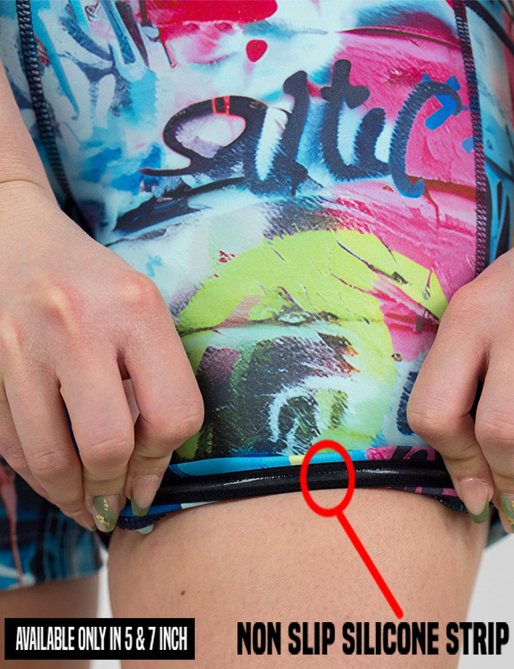 close up of the multi colored graffiti pattern shorts being rolled up to show the non slip silicone strip found in the lining of the 5 and 7 inch shorts