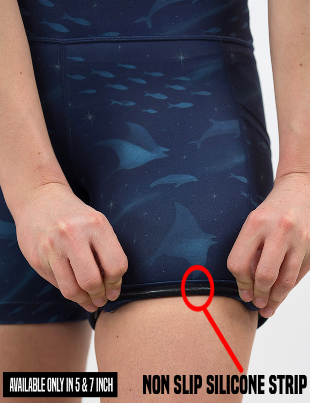 close up of the dark blue ocean filled with sting rays, whales, and fish shorts rolled up to show the non slip silicone strip found in only the 5 and 7 inch shorts