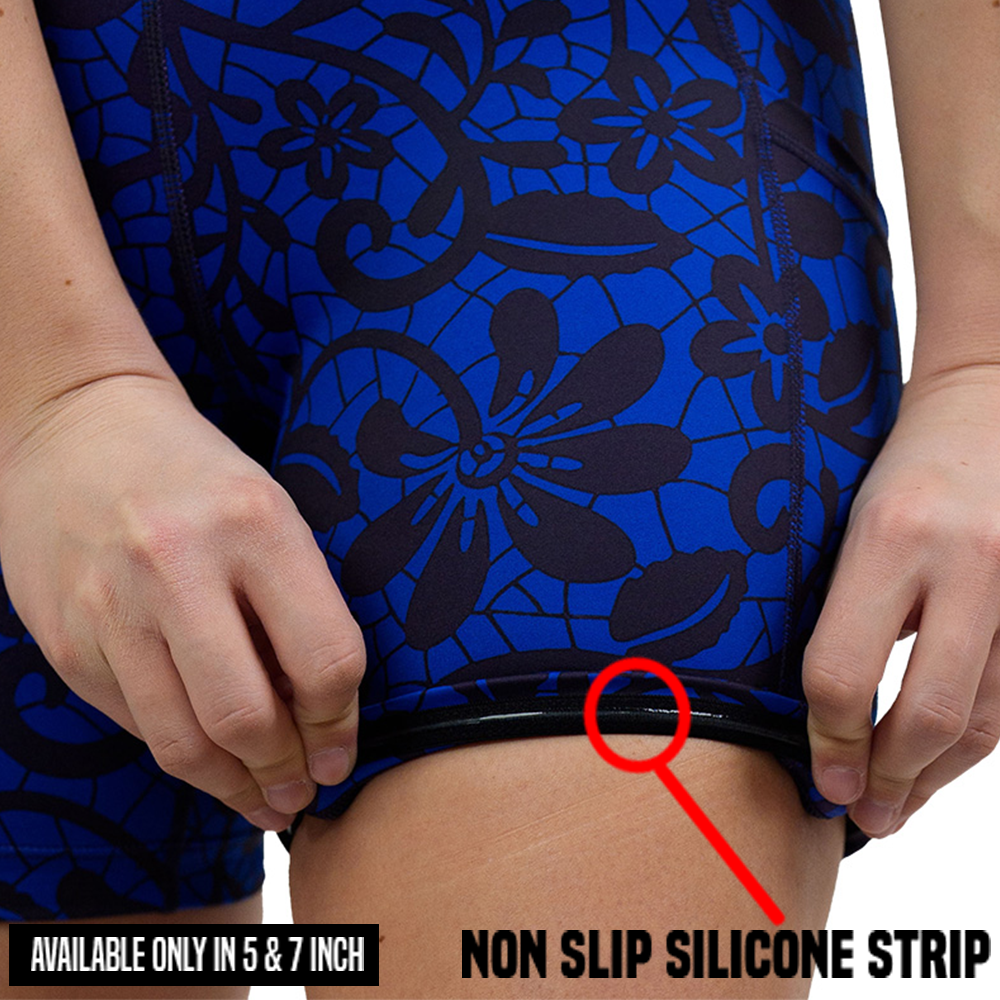 rolled up black floral against a dark blue background shorts showing the non slip silicone strip available in the 5 and 7 inch inseam sizes