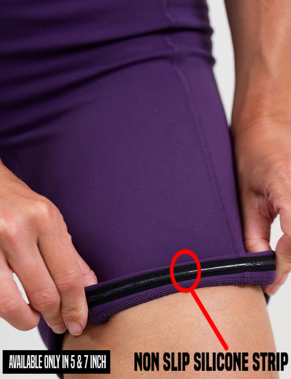 close up of the solid purple shorts being rolled up to show the non slip silicone strip found in the 5 and 7 inch shorts