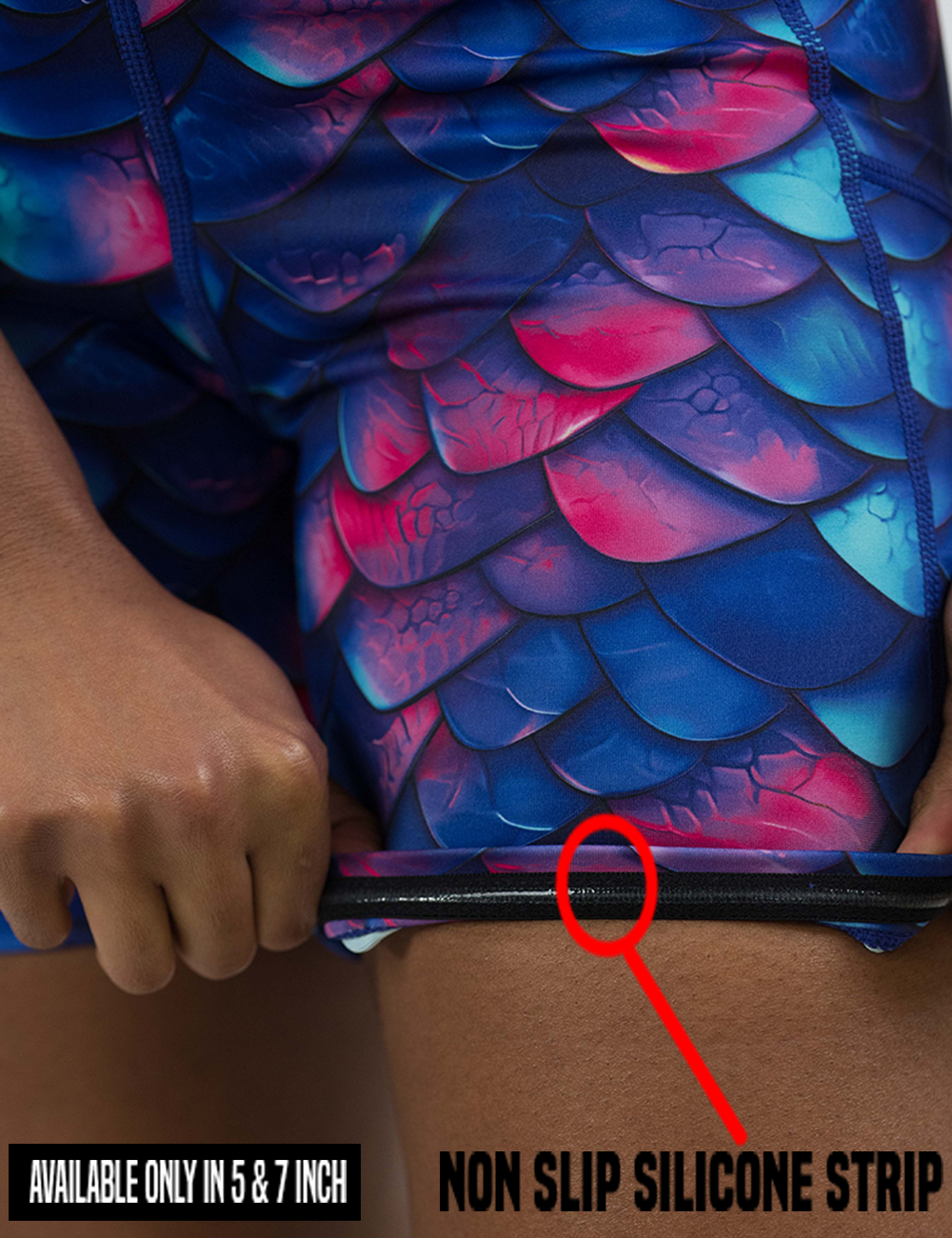 the blue, purple, and red colored dragon scale shorts rolled up to show the non slip silicone strip found in only the 5 and 7 inch inseam lengths