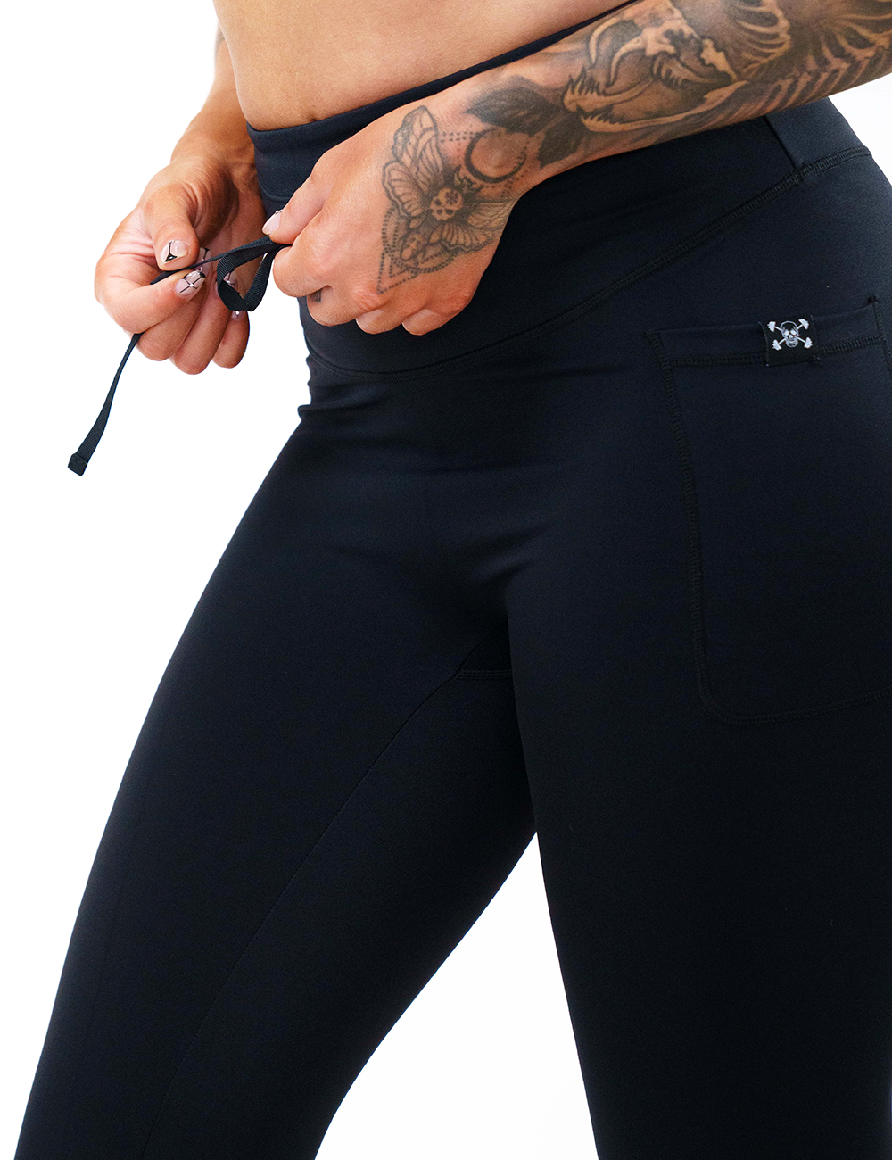close up of the draw string adjustable waist band feature against a white background