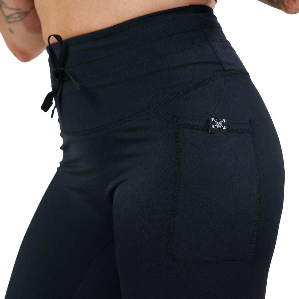 close up of the omni black leggings against a white background