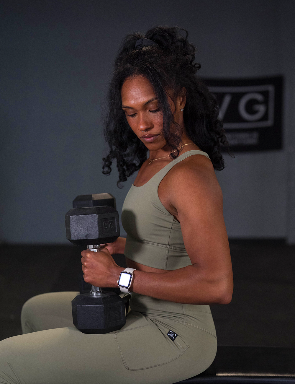 model wearing the omni green tea leggings and bra during a workout