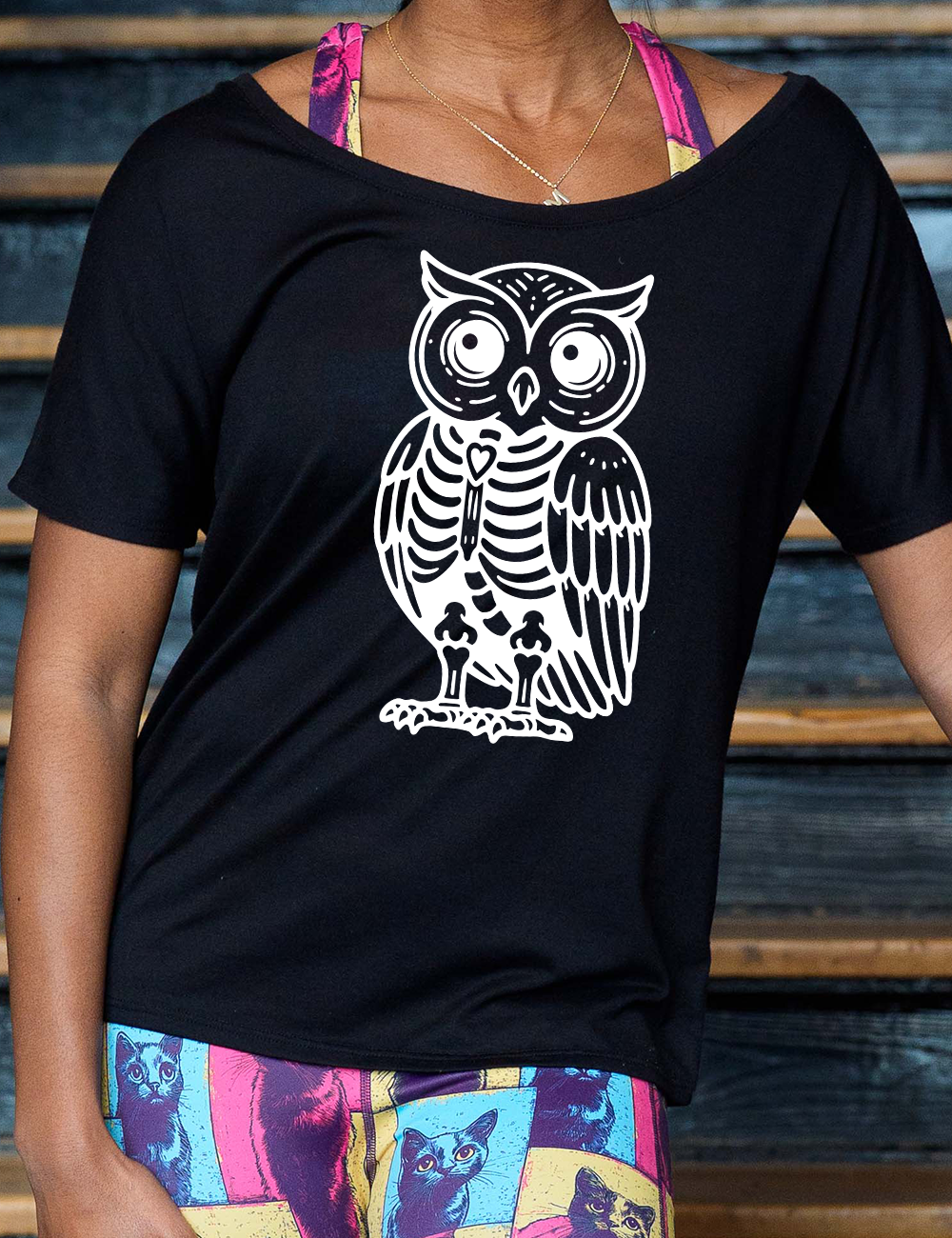 black slouchy tee with the large graphic of an owl with part of its body in skeletal form, with a little heart in the middle of its ribcage