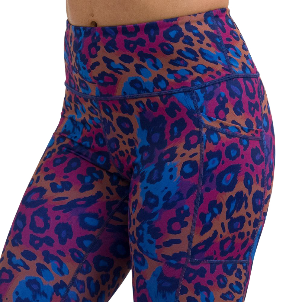 close up of cheetah print against a yellow, blue, and purple background pattern leggings against a white background