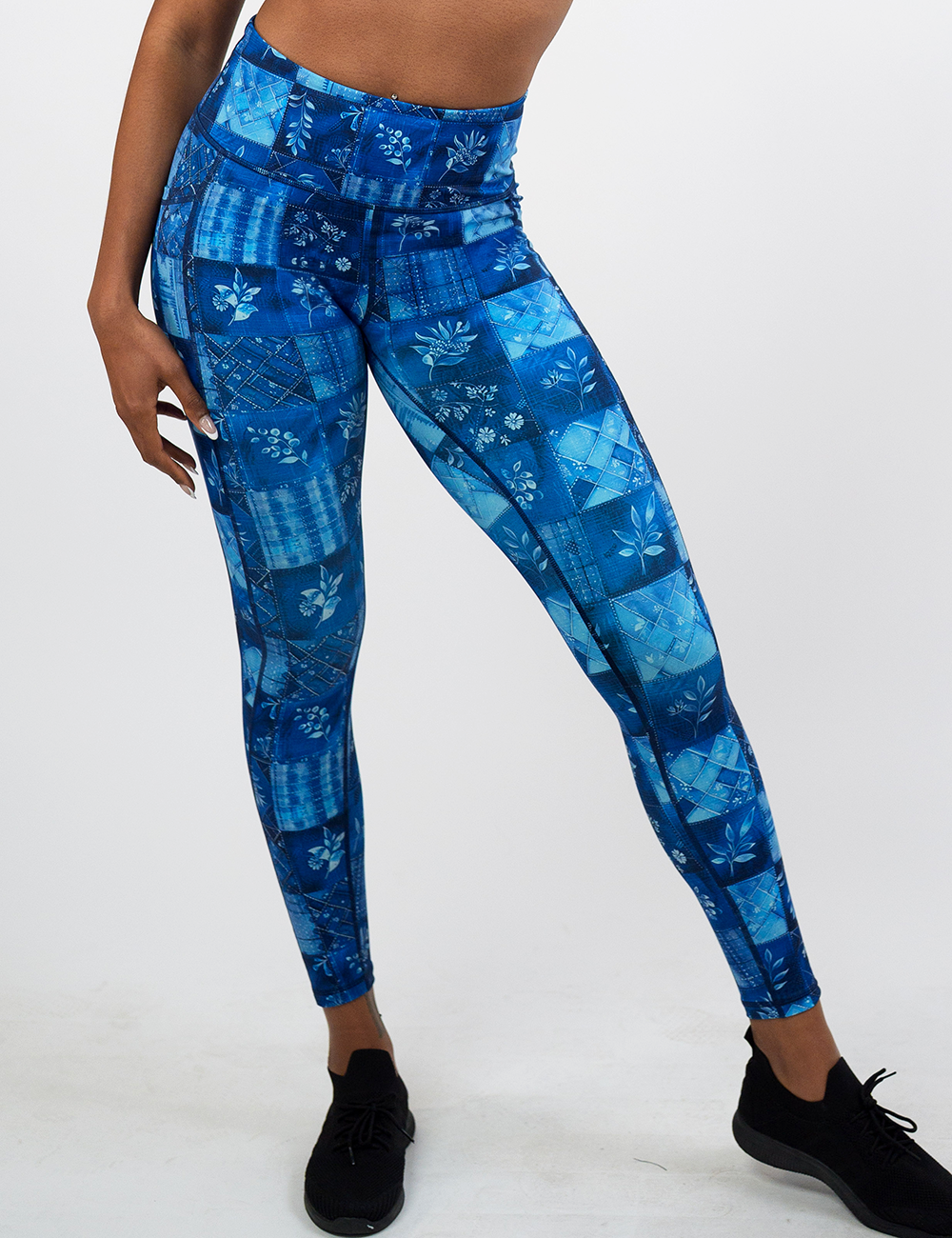 blue patch work pattern with plant designs full length leggings against a white background