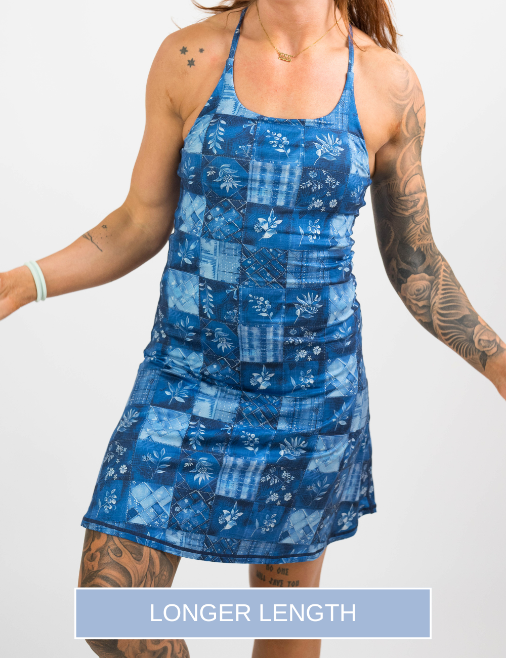 front of the longer length blue patchwork flowers dress against a white background
