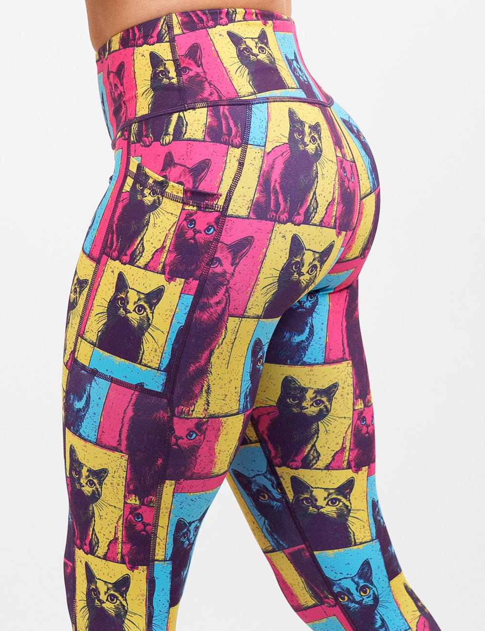 close up of the red, blue, and yellow cat patchwork print leggings against a white background