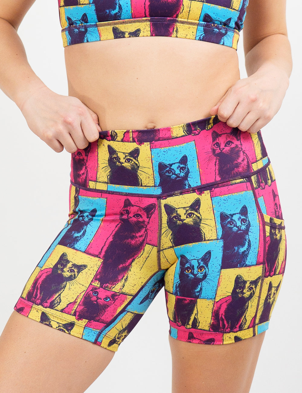 red, blue, and yellow patchwork cat print 5 inch shorts against a white background