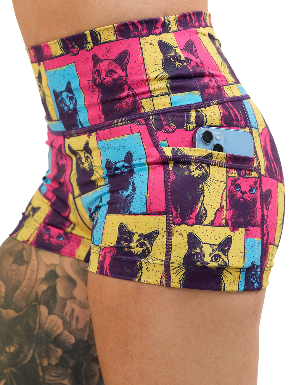 red, blue, and yellow patchwork cat print 2.5 inch shorts close up showing a phone in the pocket against a white background