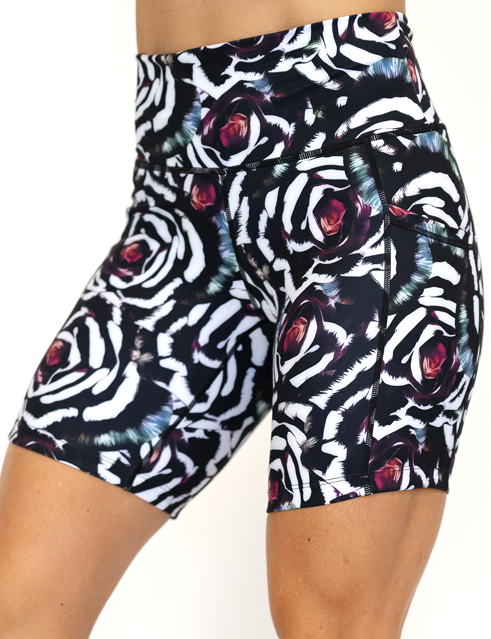 side view of blue, pink, white petal design on black 7" shorts
