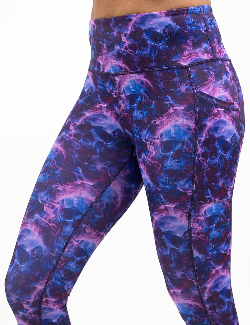 purple and blue skull and flames patterned leggings against a white background