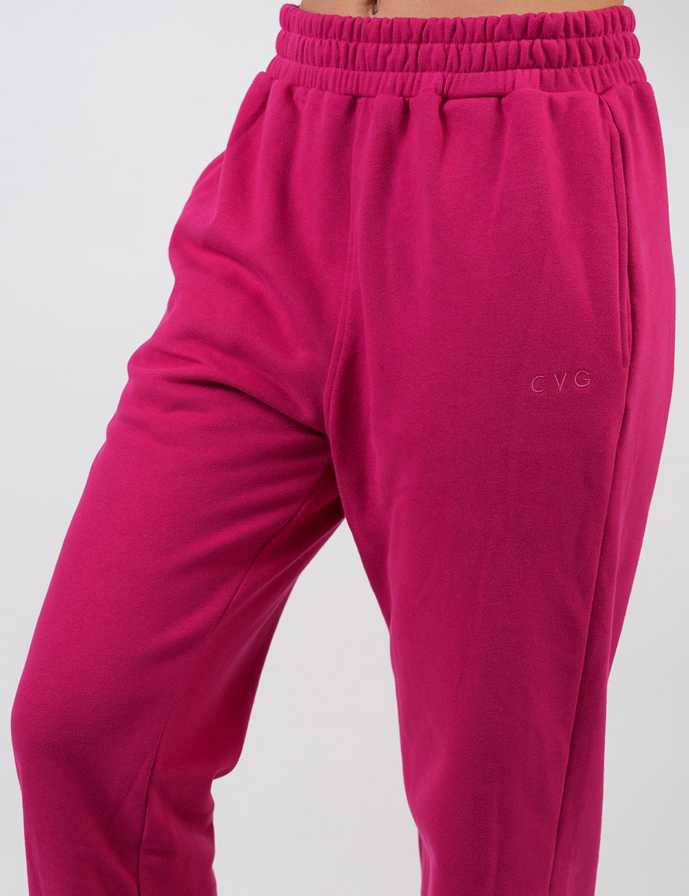 front of the pink sweatpants with a subtle CVG logo