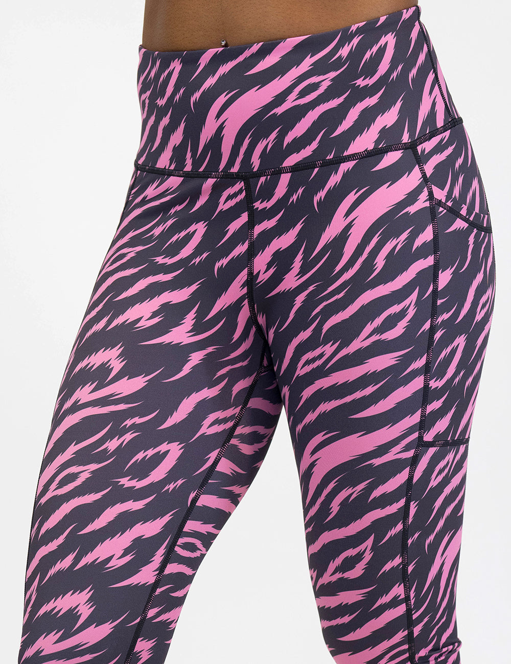 leggings with pink and black zebra pattern against a white background