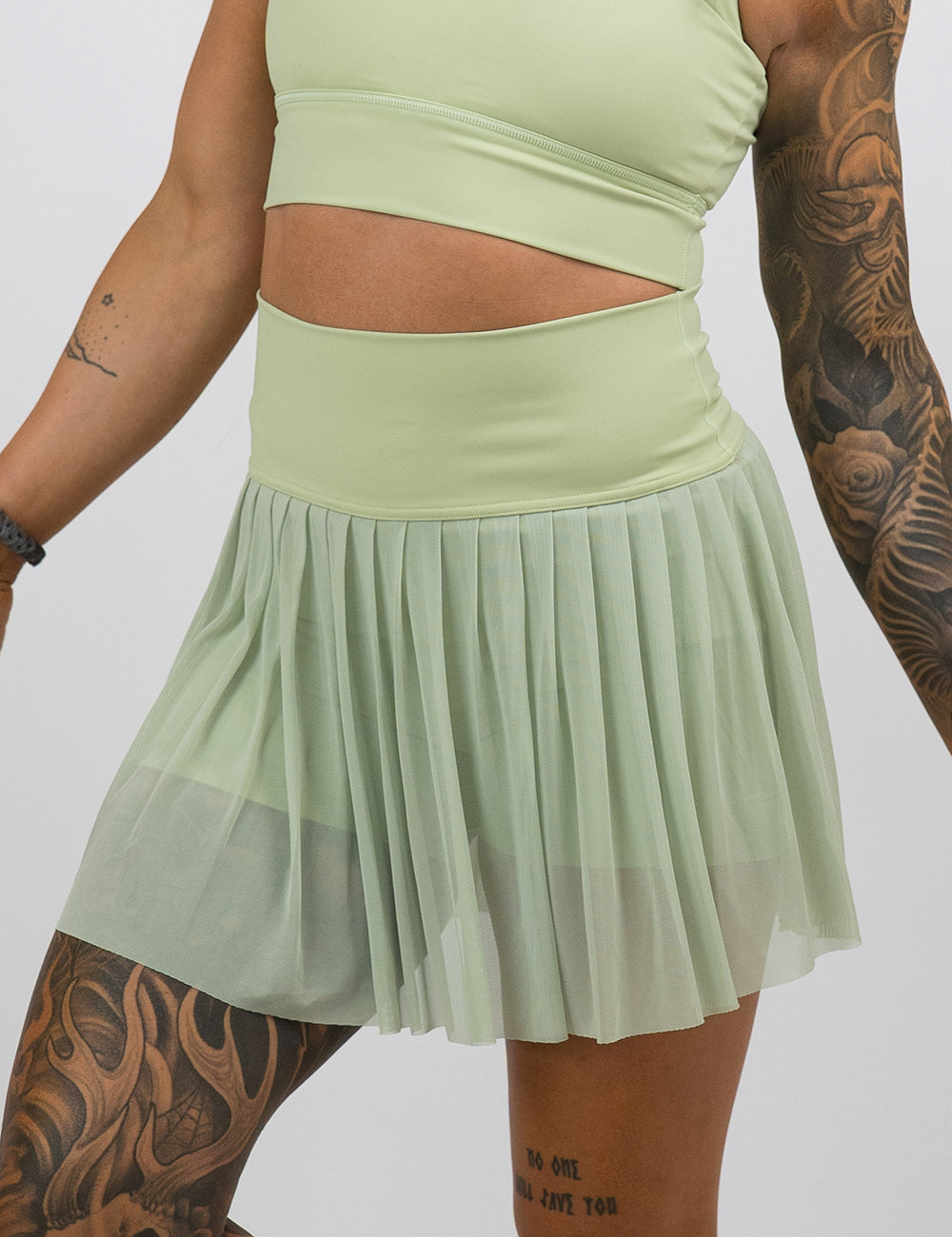 front of the light green sheer skirt against a white background