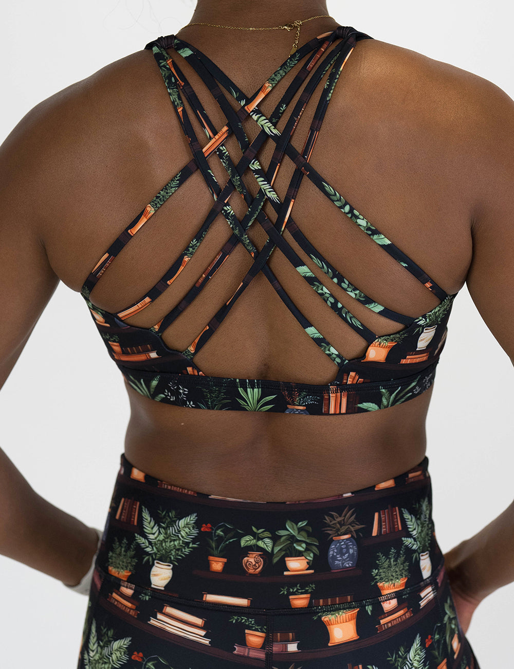 back of the floral patterned sports bra with books design on it