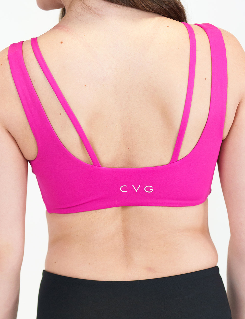 back of model wearing a hot pink sports bra