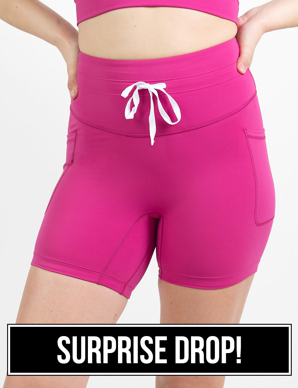 front of the 5 inch pink omni style shorts with a white drawstring against a white background, surprise drop