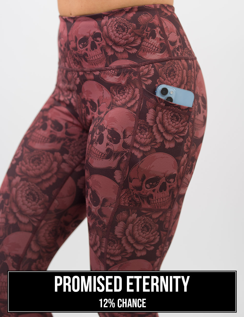 side view of the red skulls with flower leggings with a phone in its pocket, the name of this print is promised eternity and it has a 12% chance of being unboxed