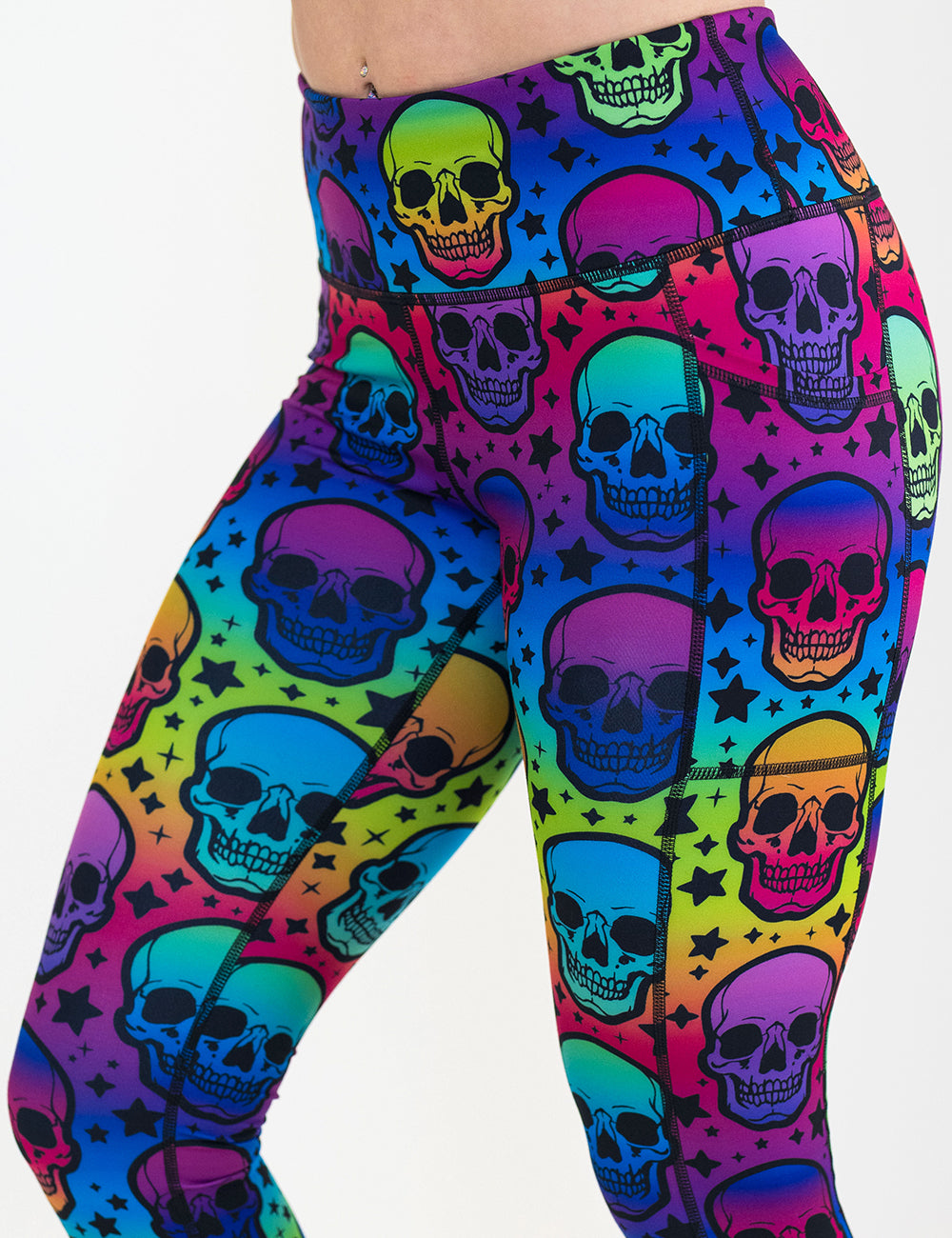 front of the rainbow skulls patterned leggings against a white background