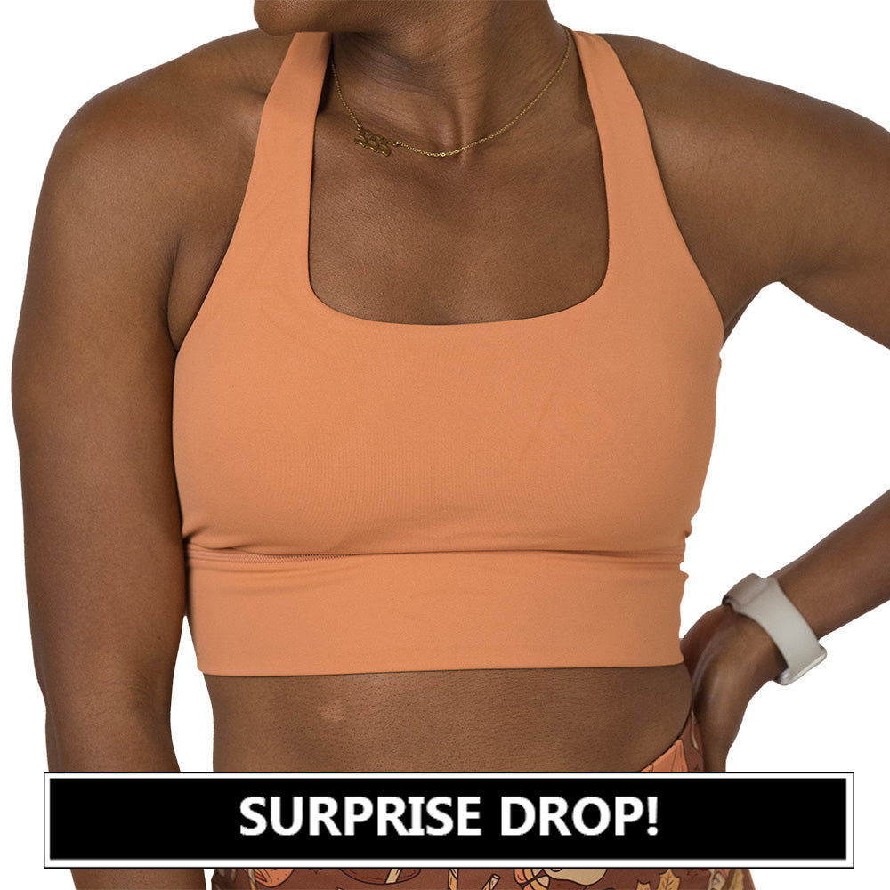 Person wearing a peach-colored sports bra