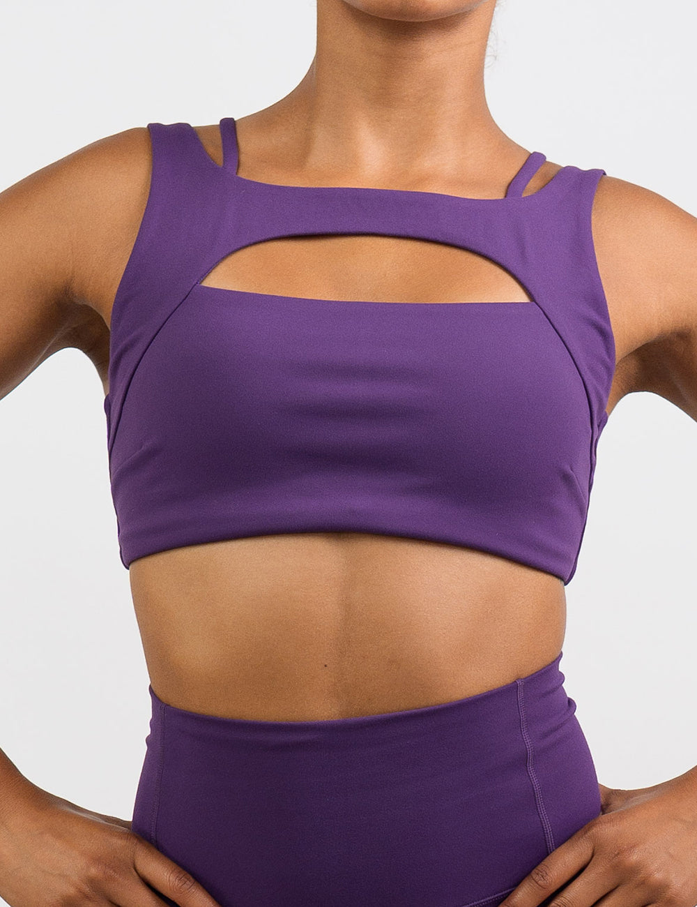 front of the solid purple sports bra against a white background