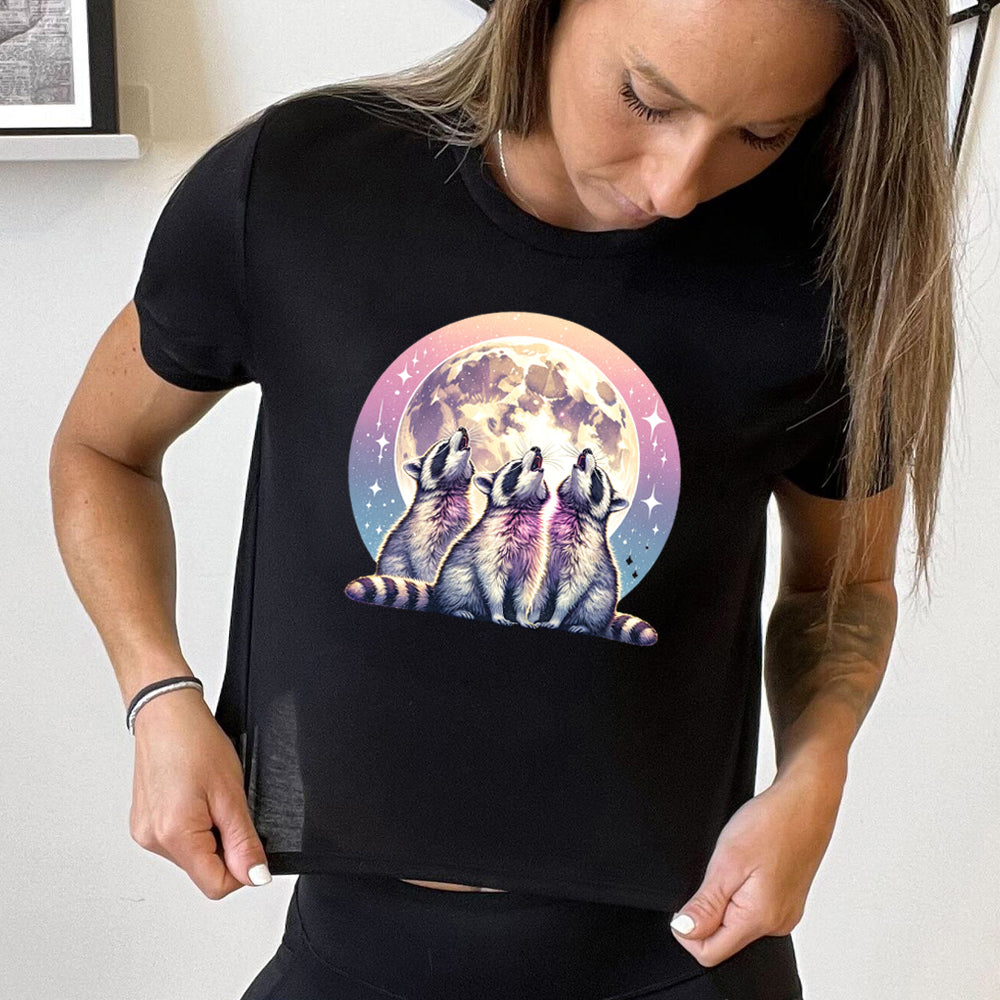 black cropped tee with a raccoon and moon graphic on it