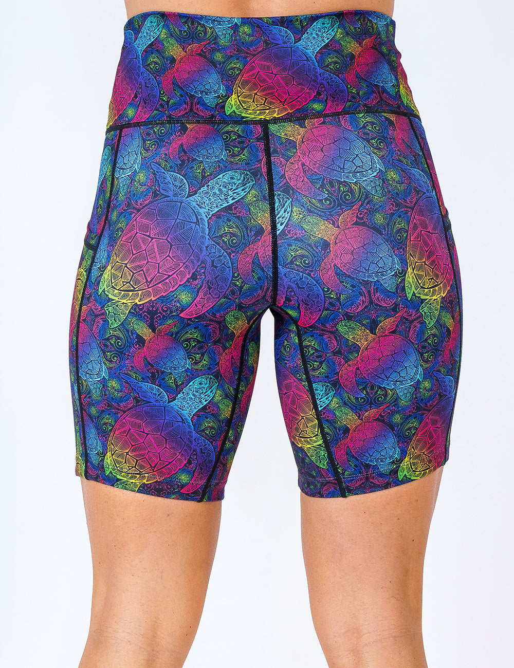 back of the 7 inch pink, yellow, blue, green and purple ombre turtle print shorts against a white background