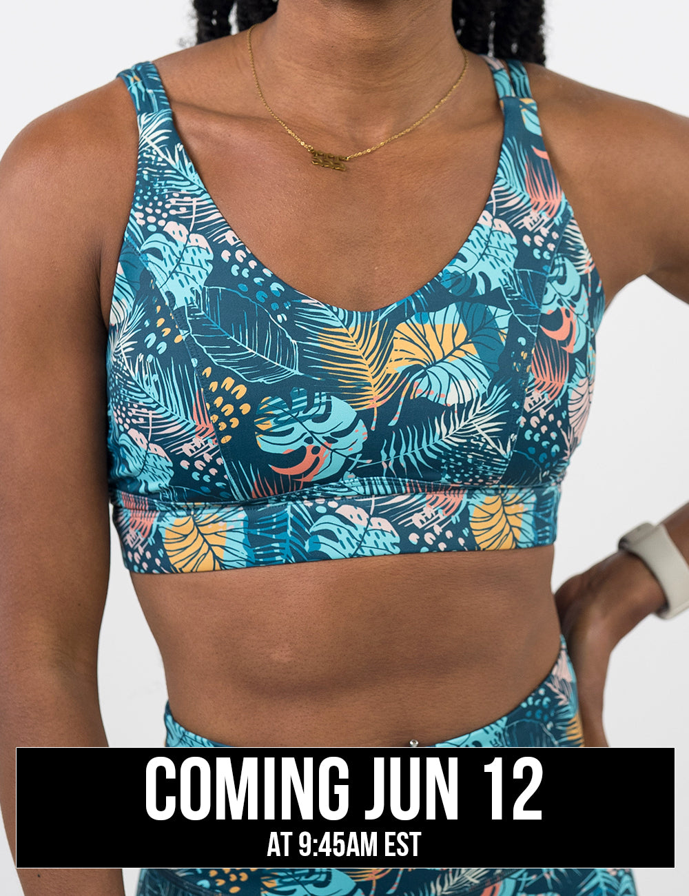 front of the blue, yellow, pink, and red tropical leaves print vitality bra against a white background, coming june 12th